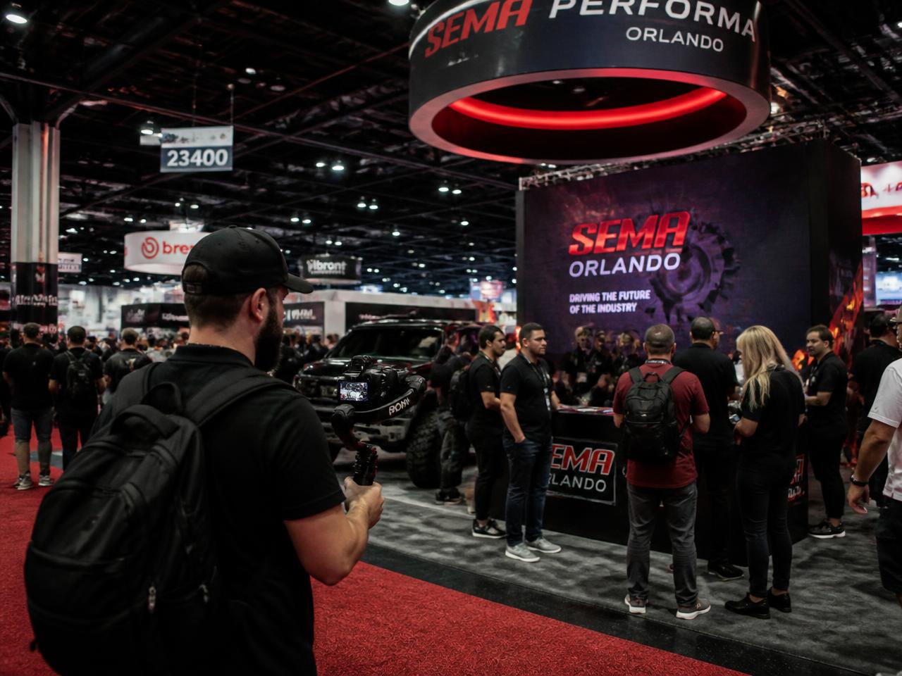 Videographer filming booth coverage at an Orlando trade show